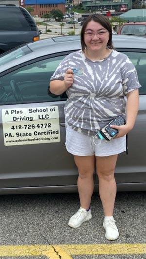 Emily gets her driver's license on her first try with a perfect score!